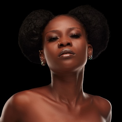 A woman with an afro is wearing a dress