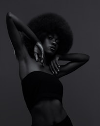 A black and white photo of a woman with an afro