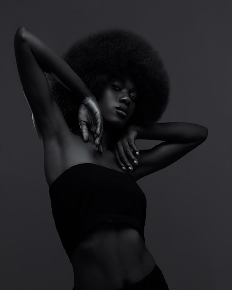 A black and white photo of a woman with an afro
