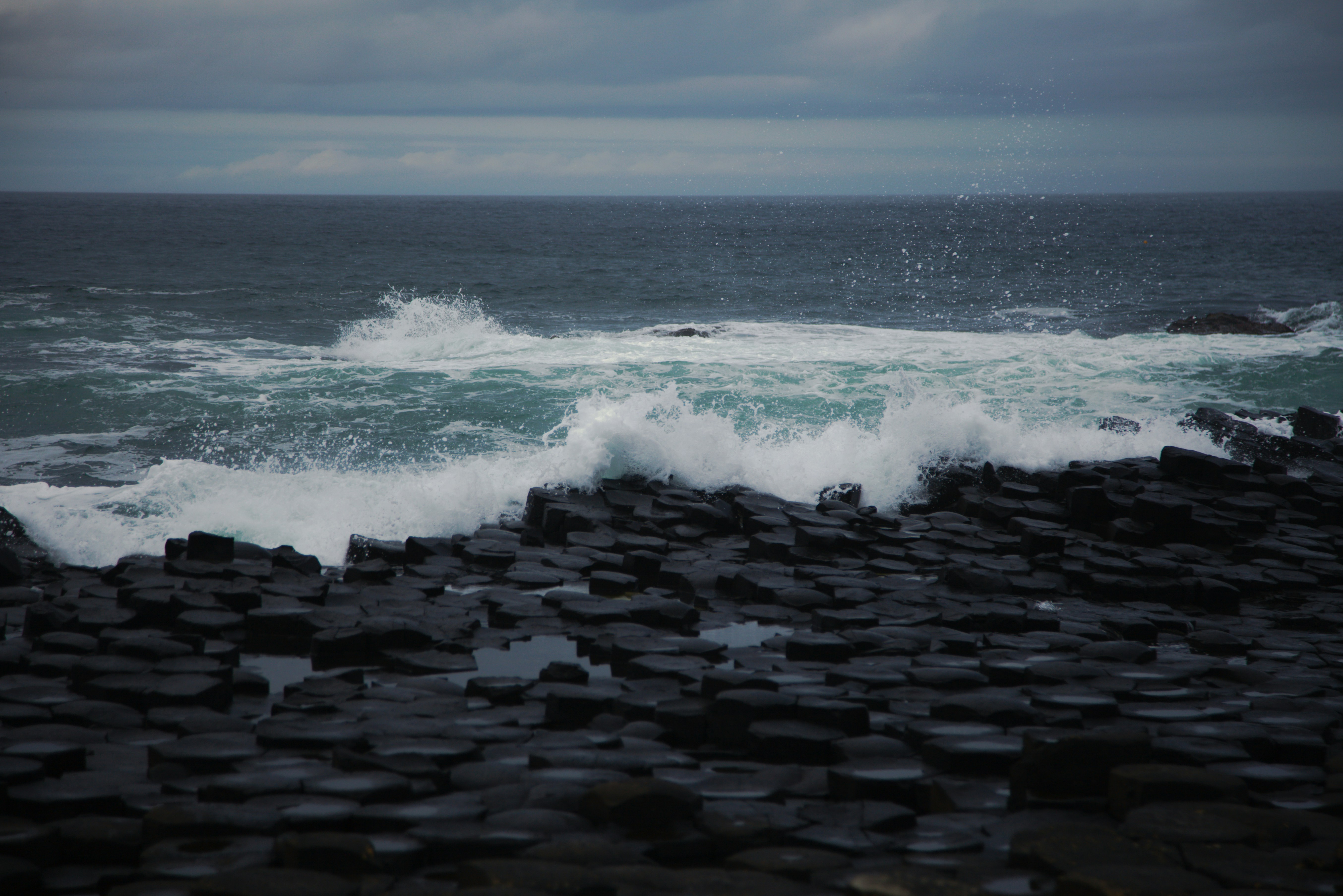 A large body of water near a rocky shore