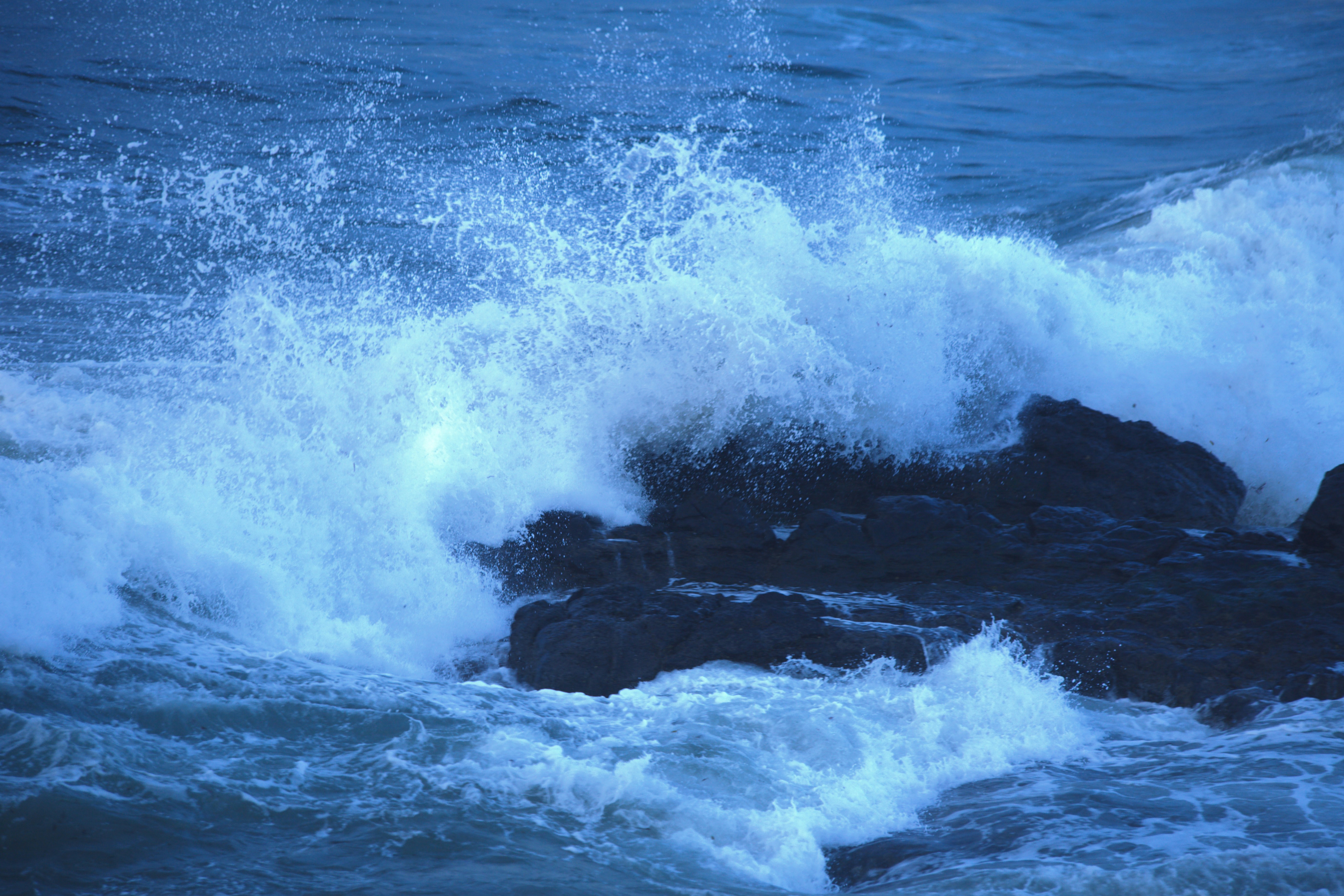 A person riding a surfboard on top of a wave