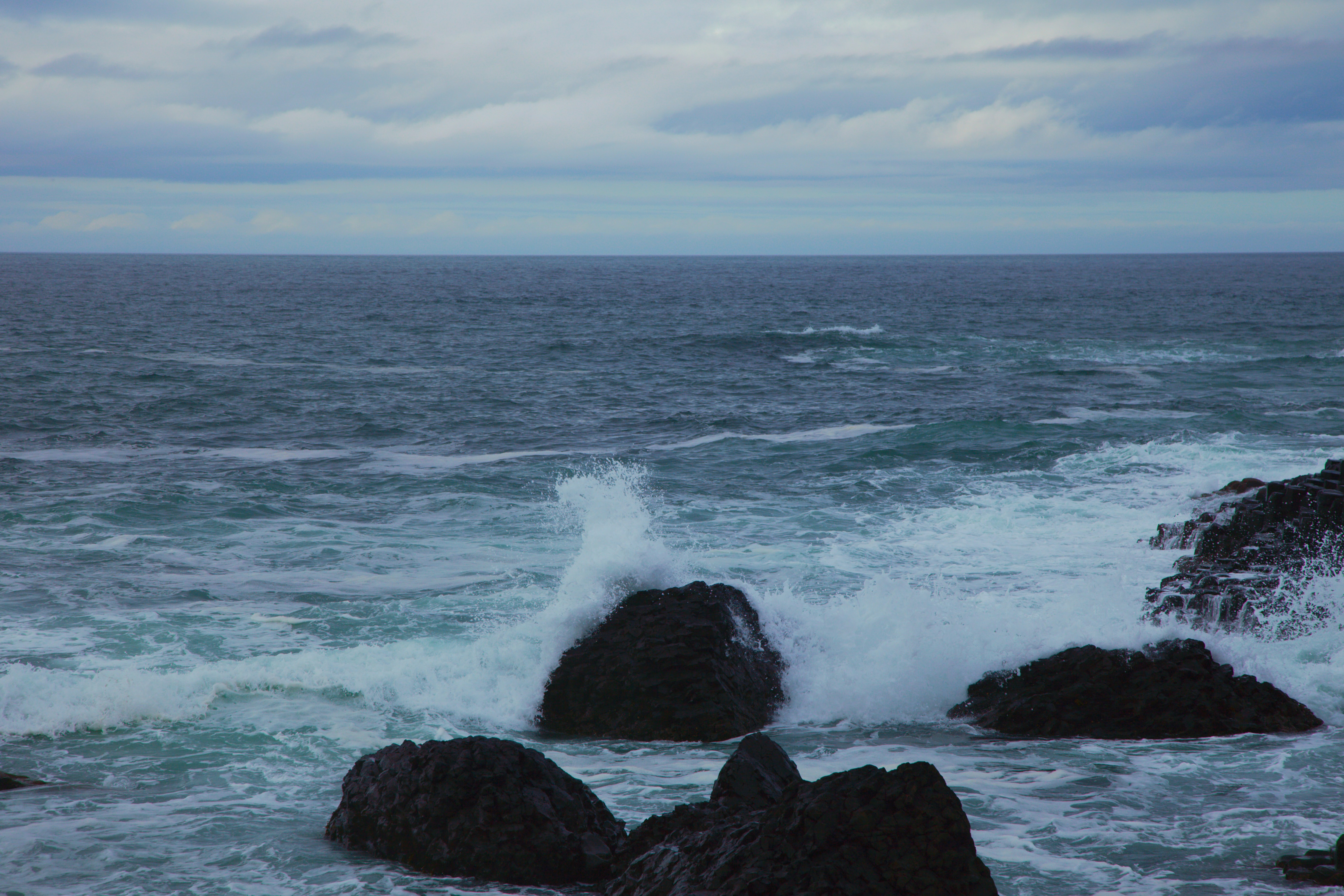 A large body of water surrounded by rocks