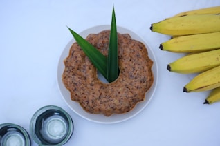 A plate of food with bananas and a jar of yogurt