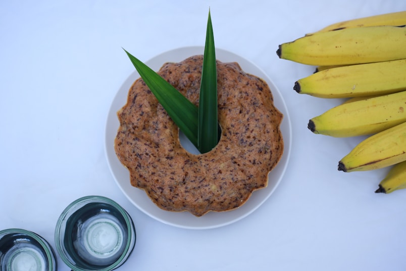A plate of food with bananas and a jar of yogurt