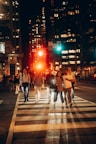 A group of people crossing a street at night