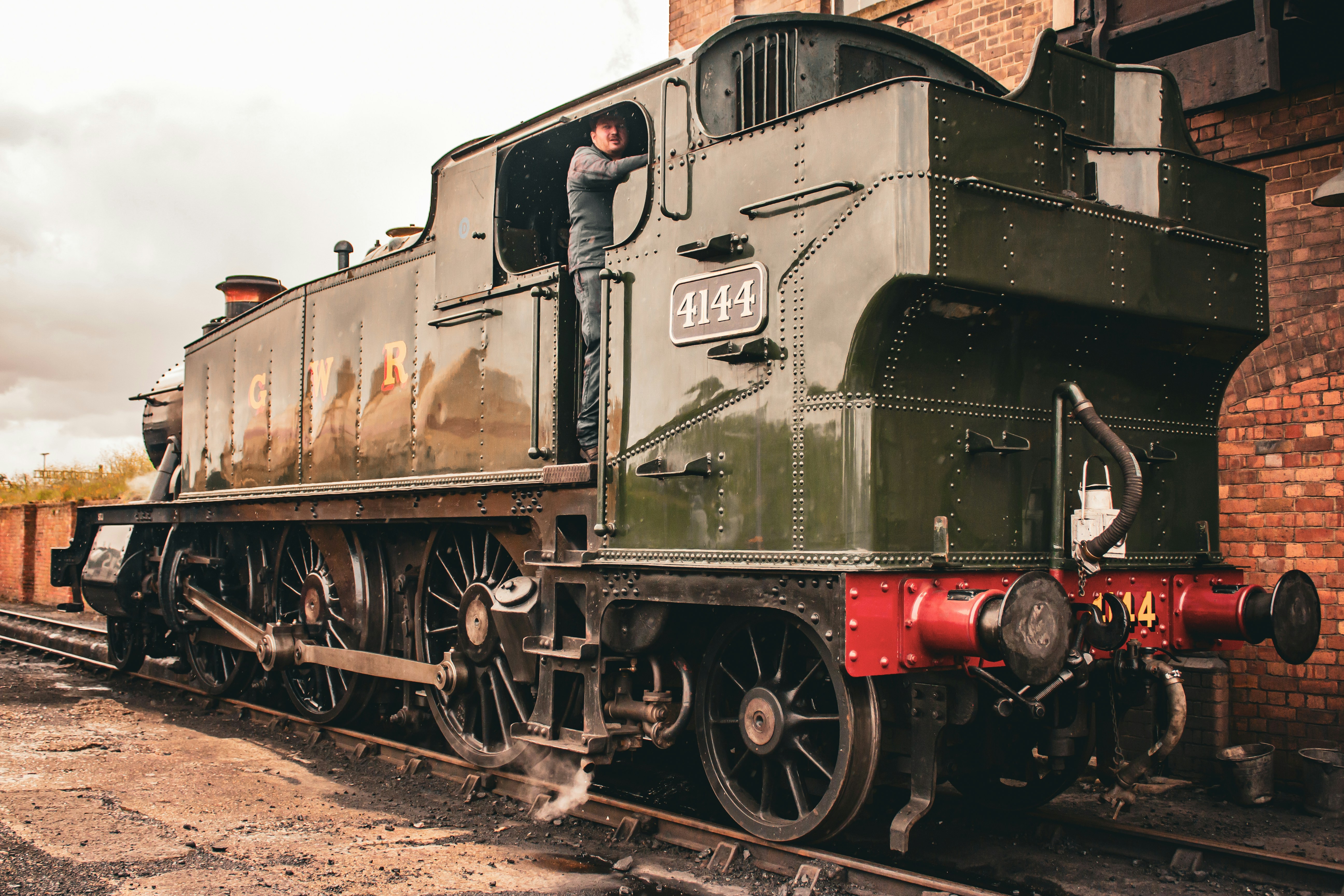 A man standing on the side of a train