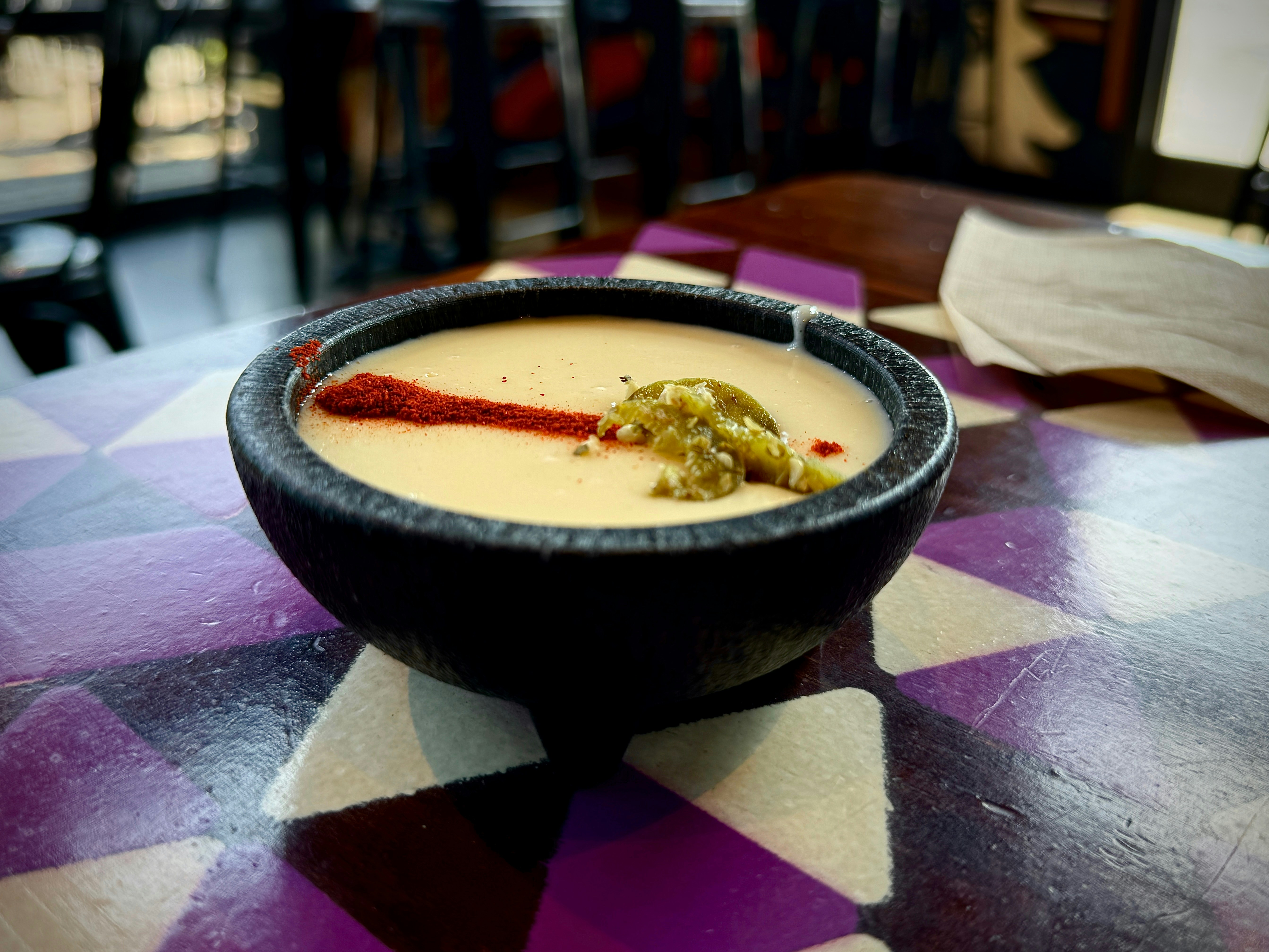 A bowl of soup on a table in a restaurant