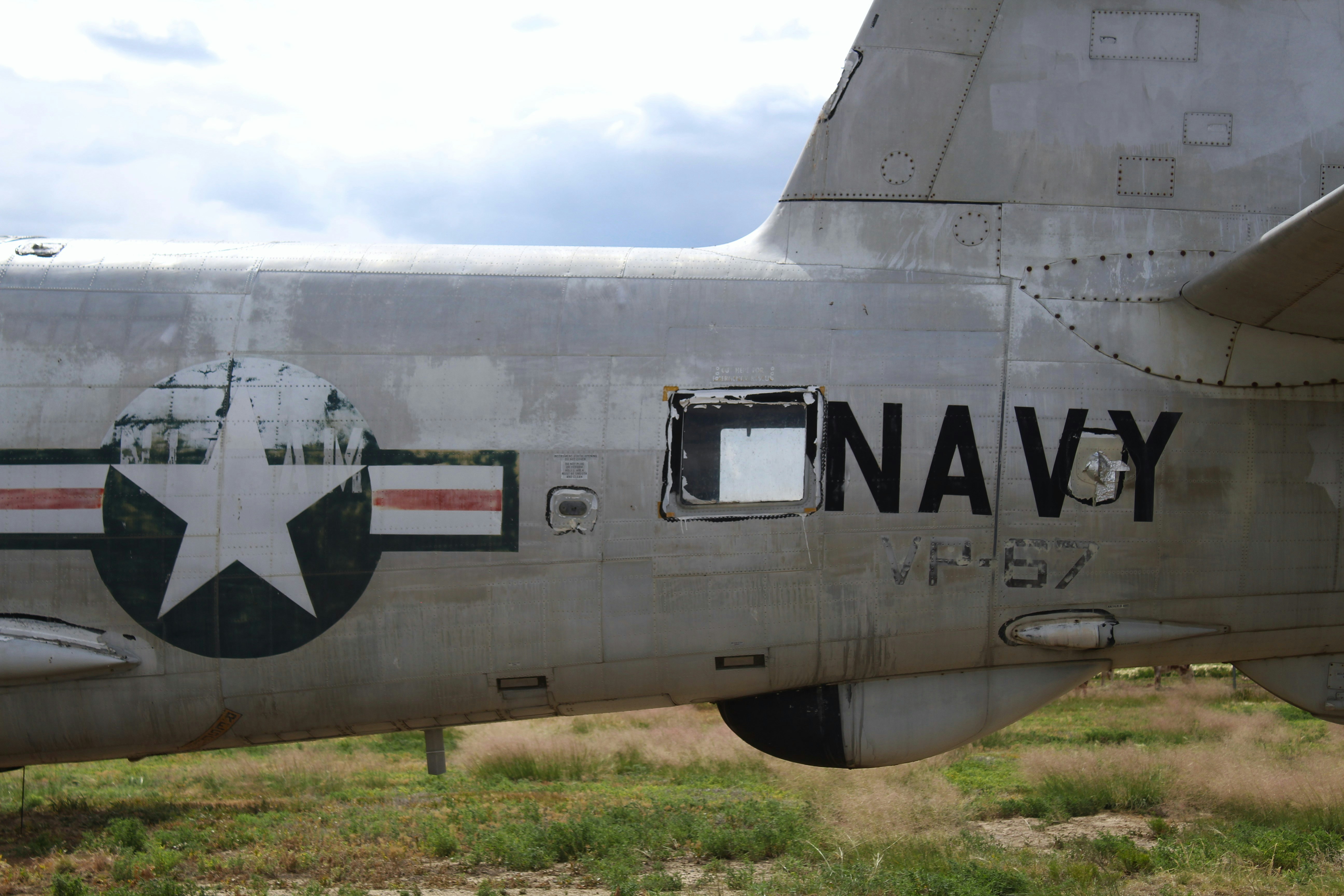 An old military plane sitting in a field
