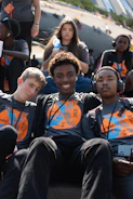 A group of young men sitting next to each other
