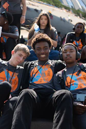 A group of young men sitting next to each other