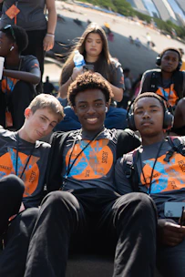 A group of young men sitting next to each other