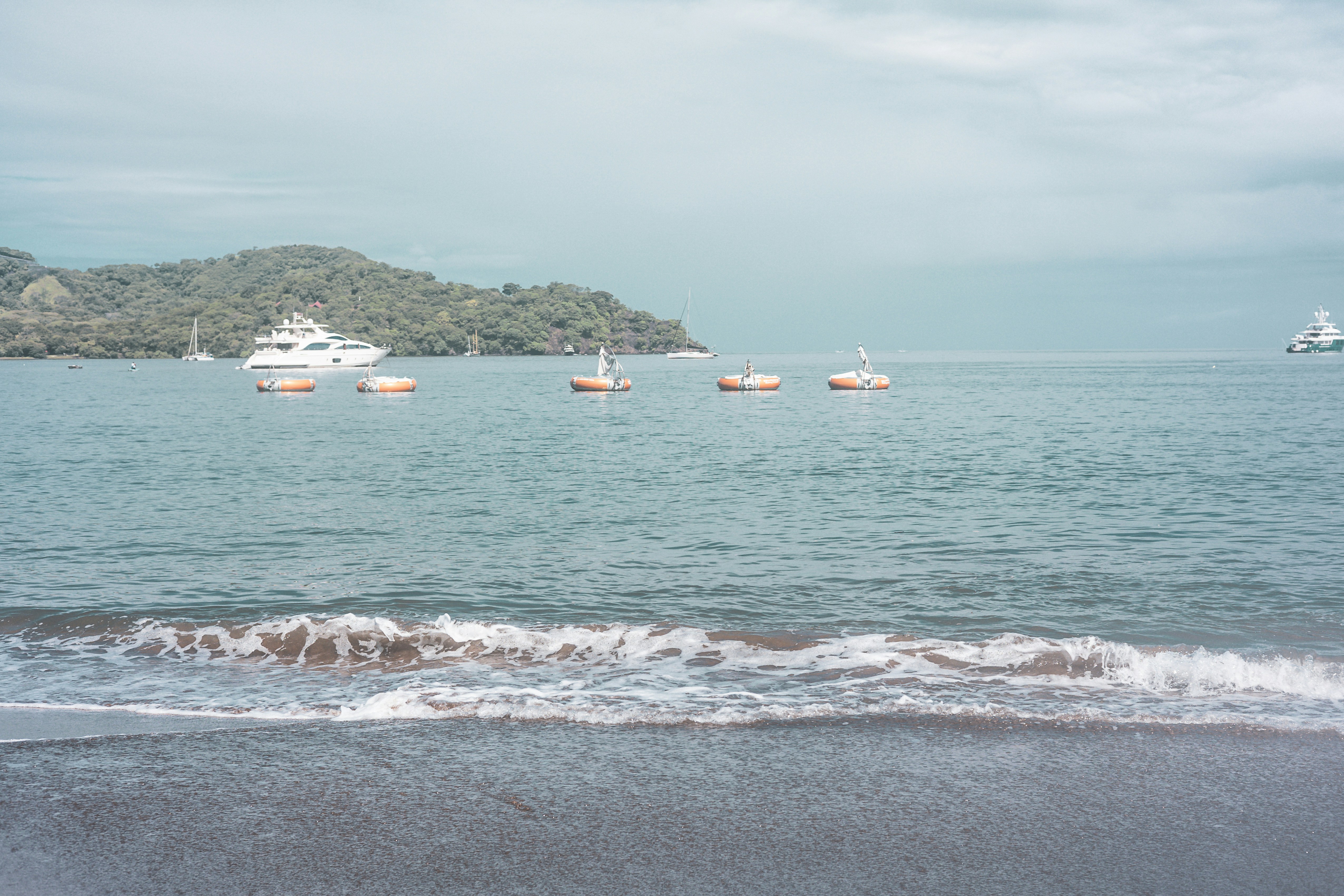 A body of water with boats in the distance