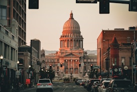 A city street with a large building in the background