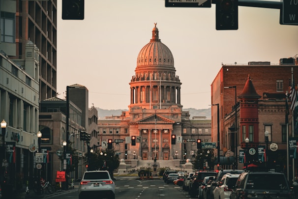 A city street with a large building in the background