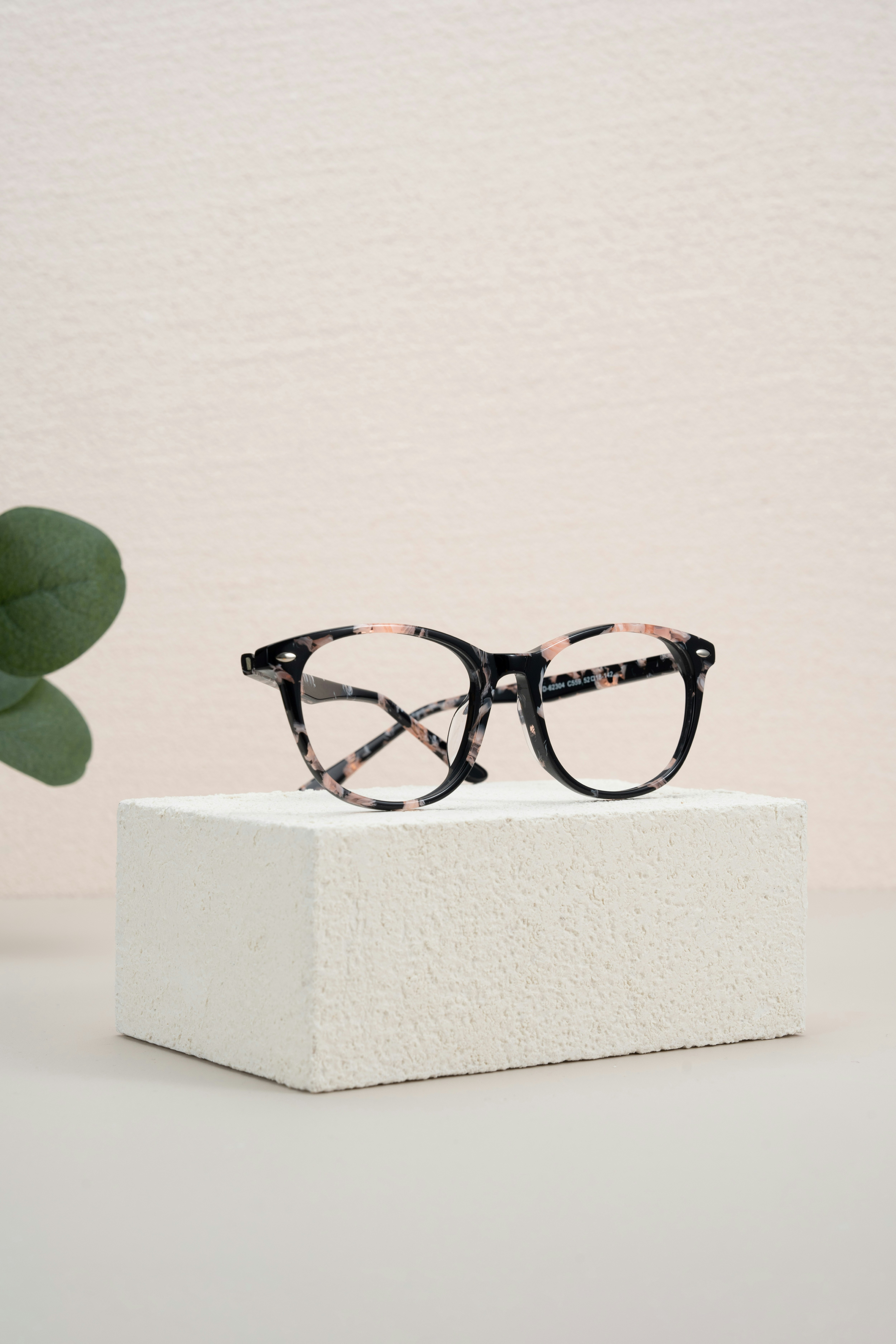 A pair of glasses sitting on top of a white block