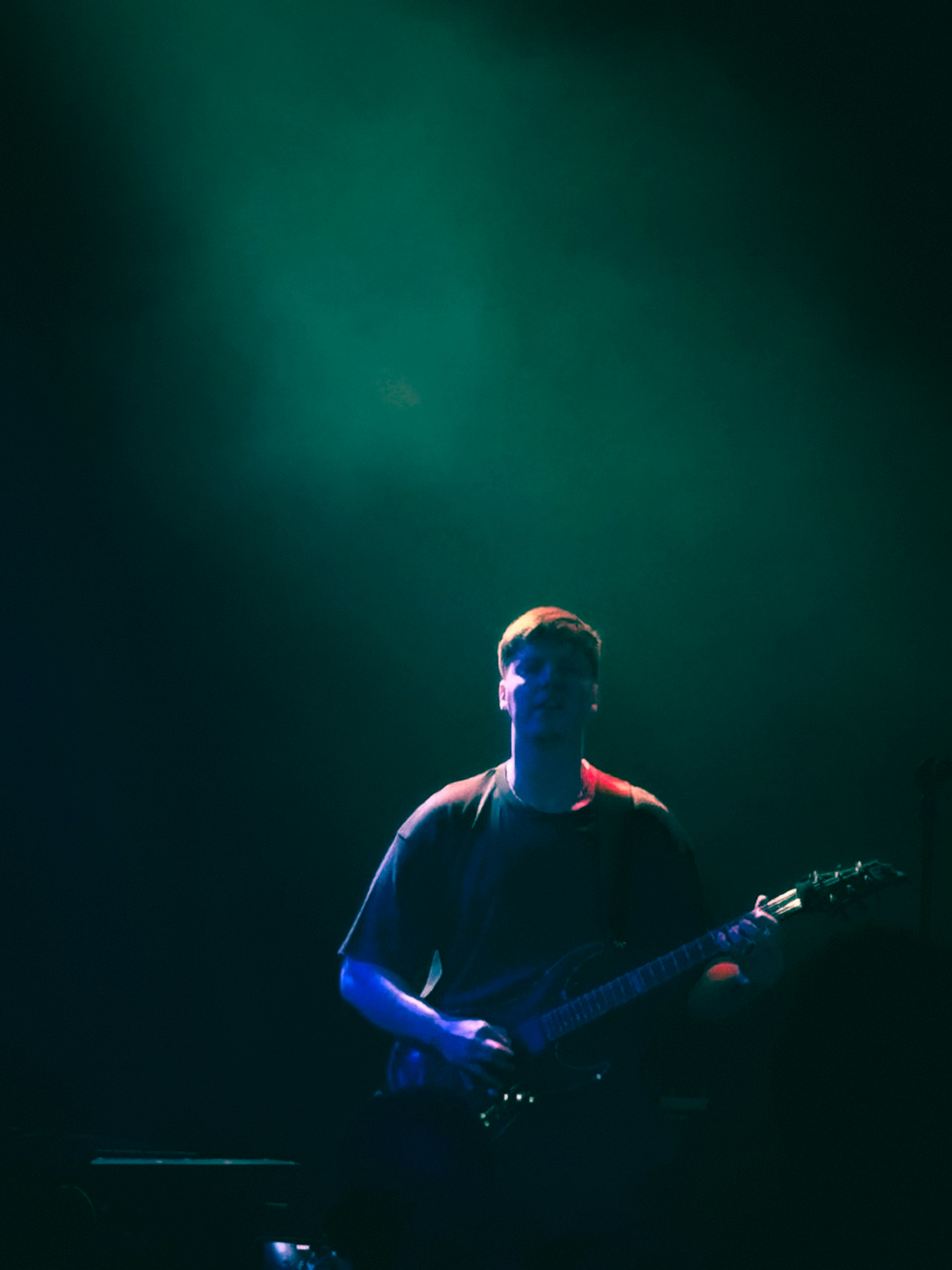 A man playing a guitar on a stage