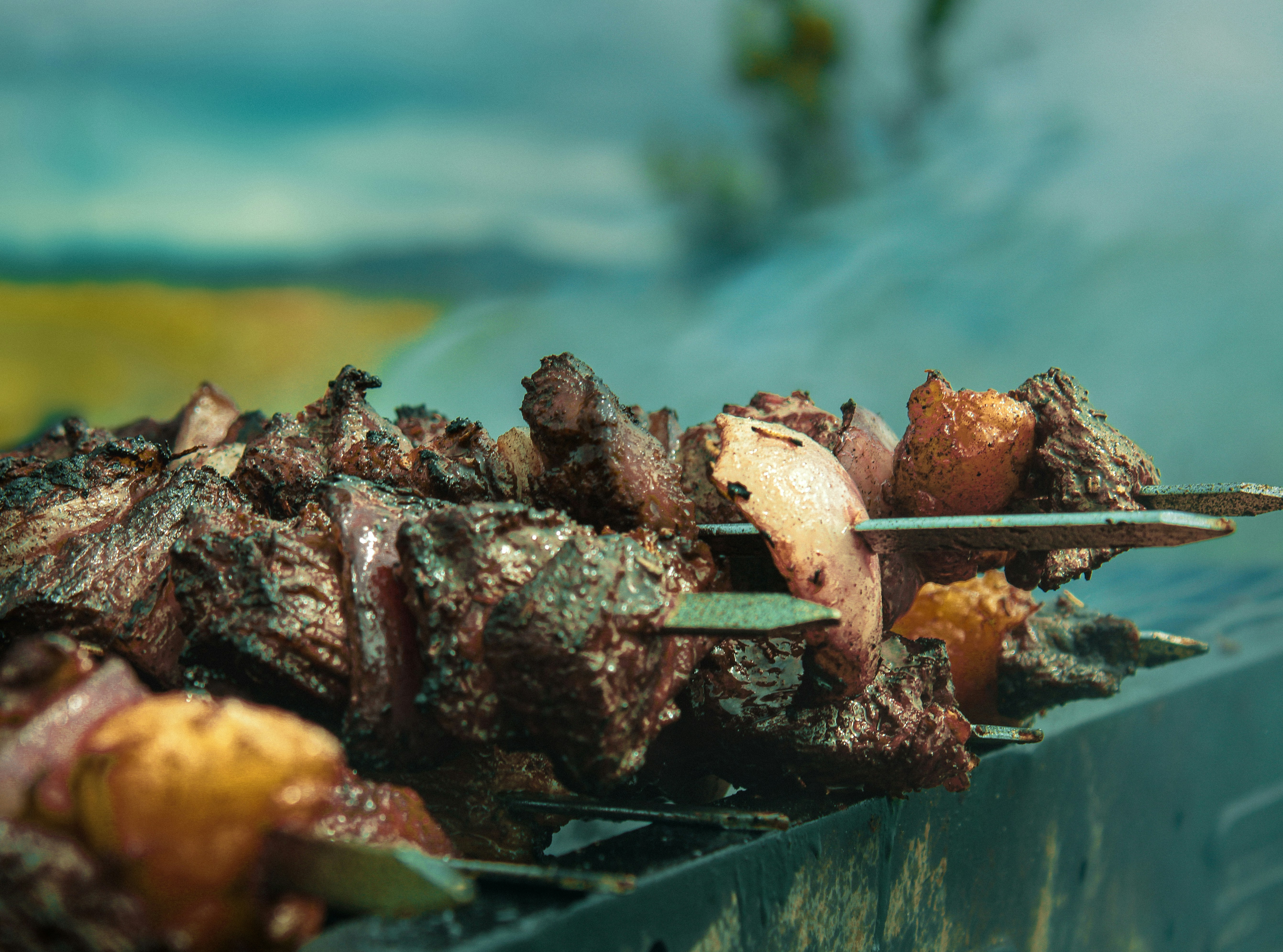 A close up of a skewer of food on a grill