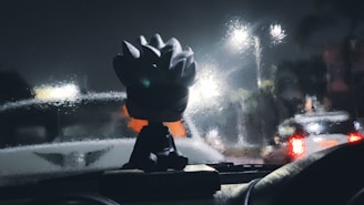 A man driving a car at night with a helmet on