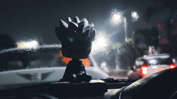 A man driving a car at night with a helmet on