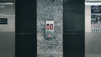 An elevator with a red light on the side of it