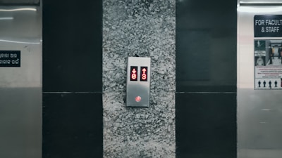 An elevator with a red light on the side of it