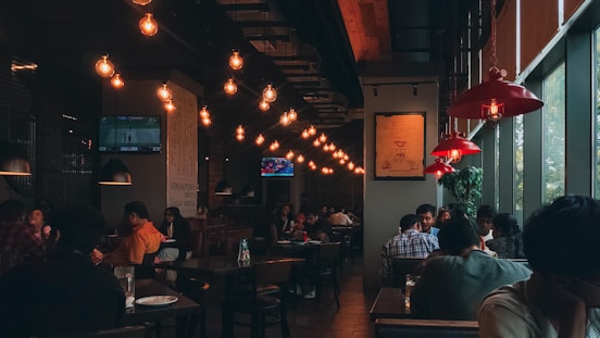 A group of people sitting at tables in a restaurant