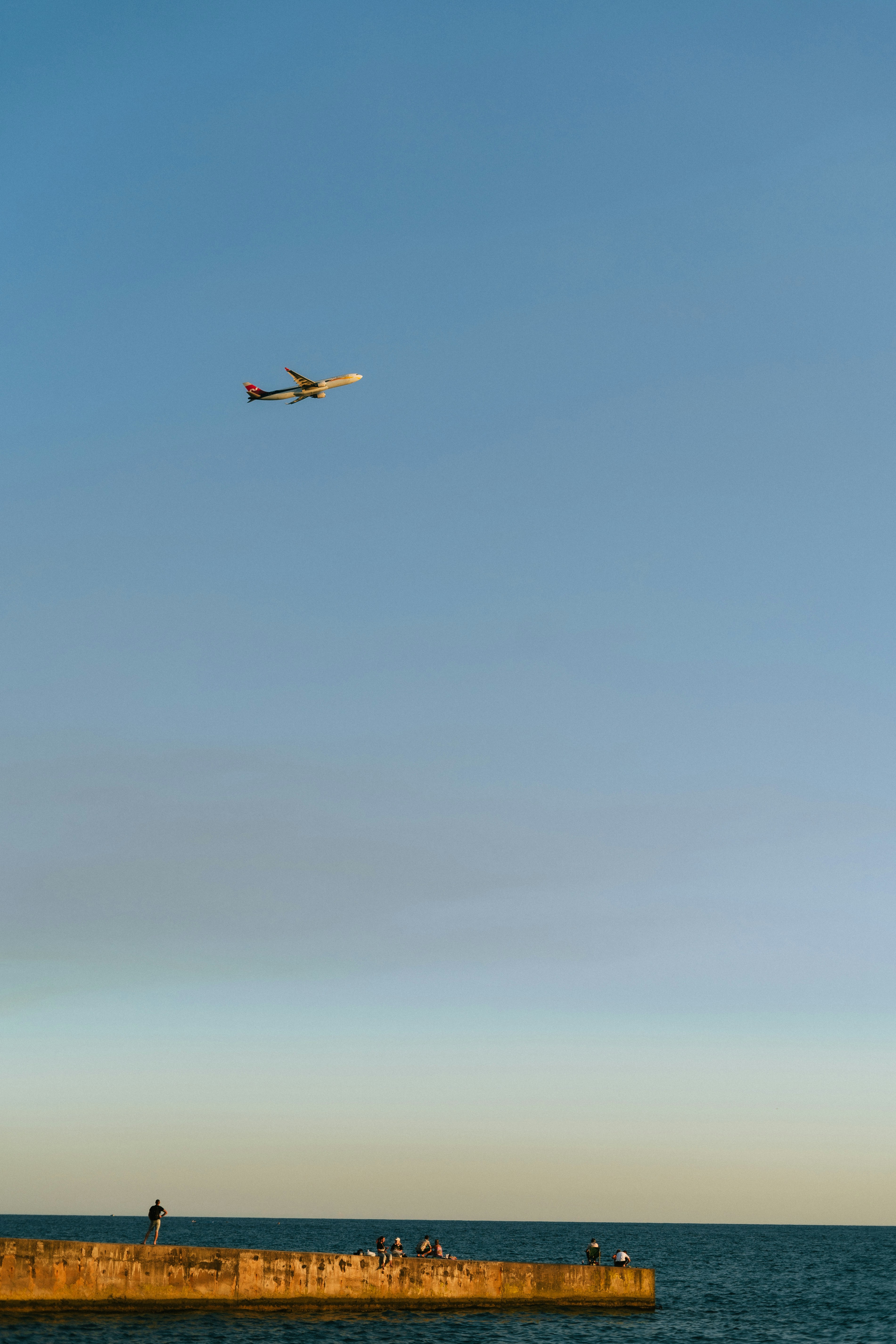 A plane flying over a body of water