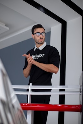 A man standing in front of a mirror wearing glasses