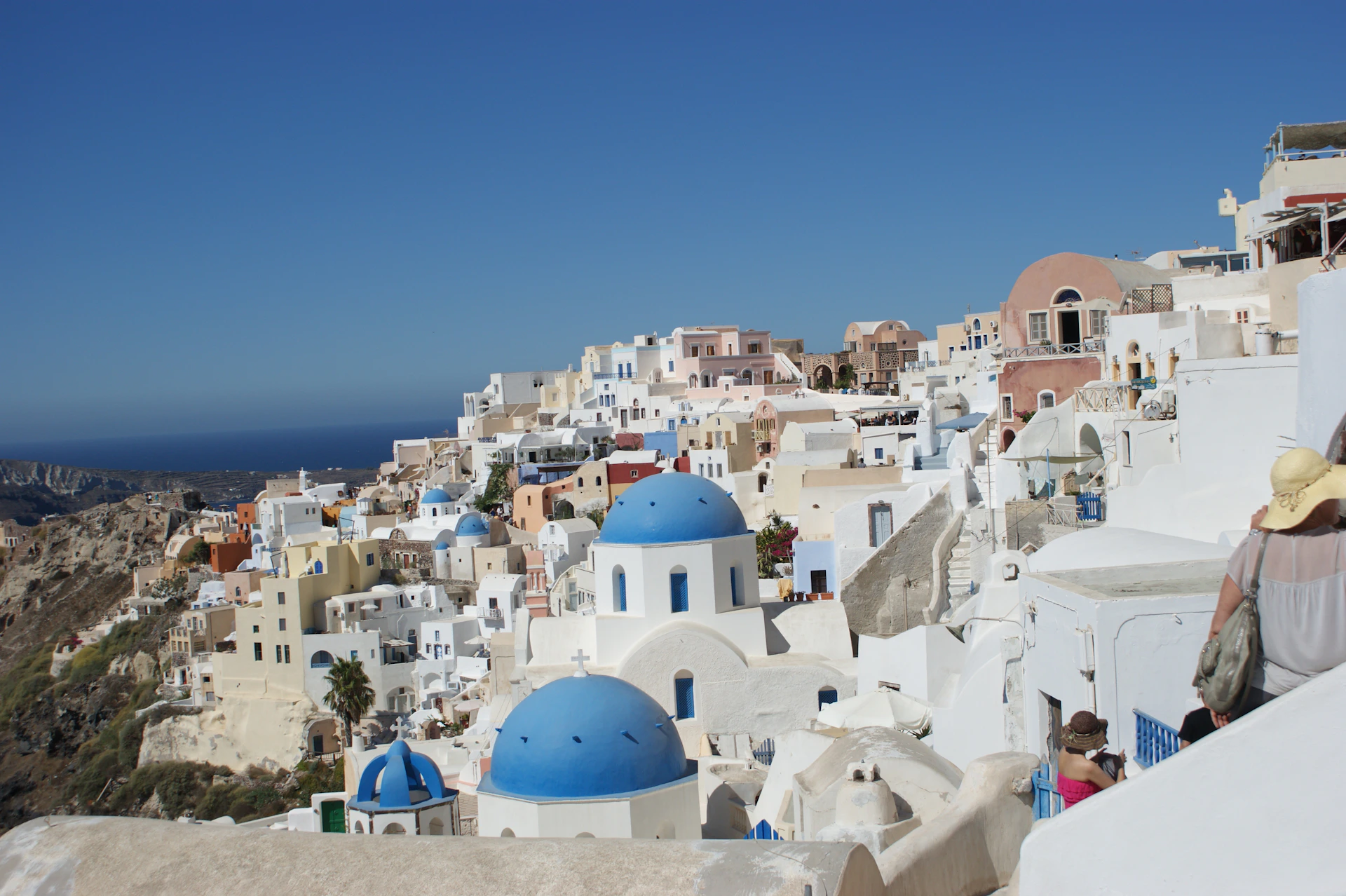 A view of a city with white buildings and blue domes