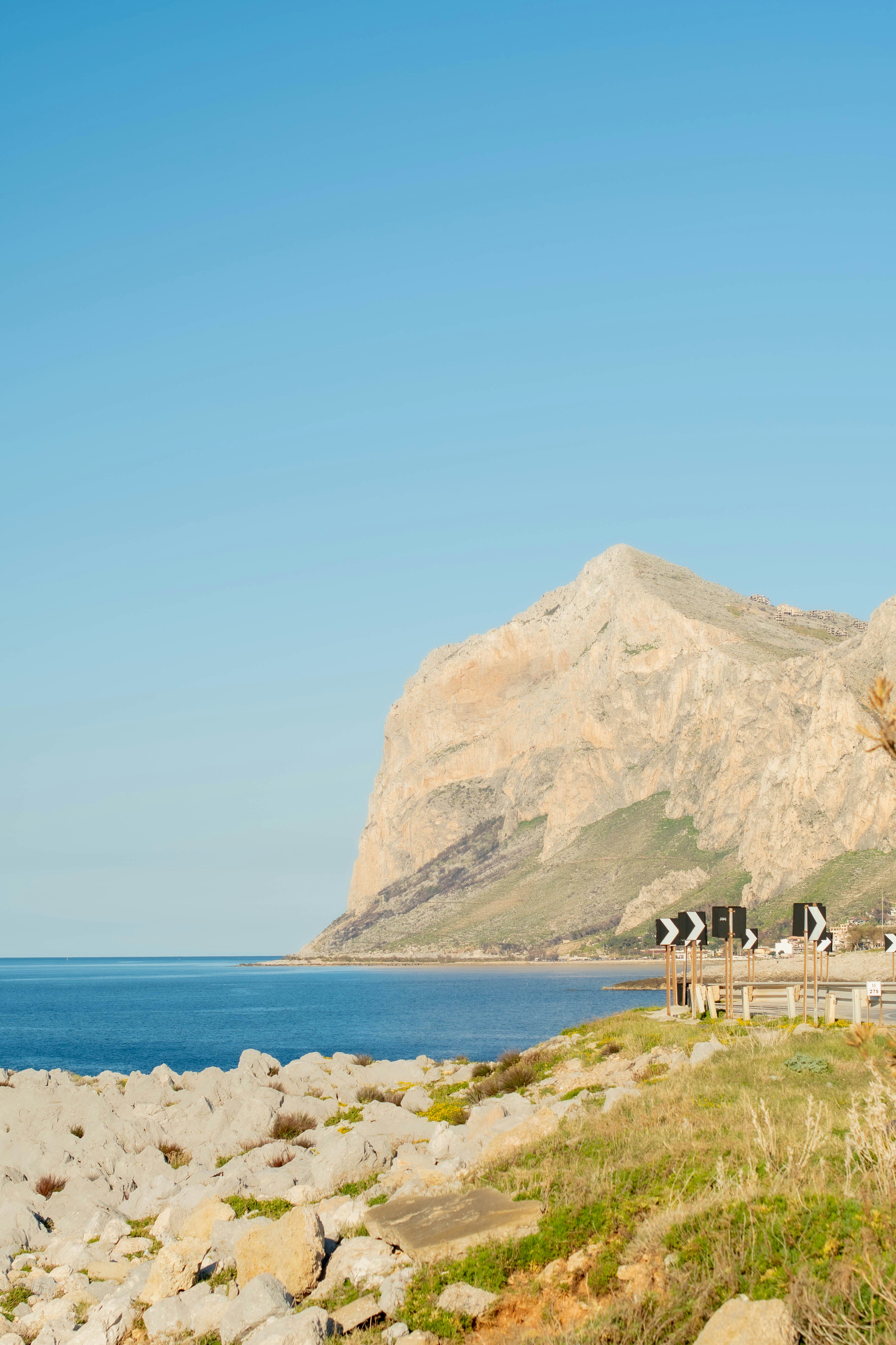 A view of a rocky beach with mountains in the background