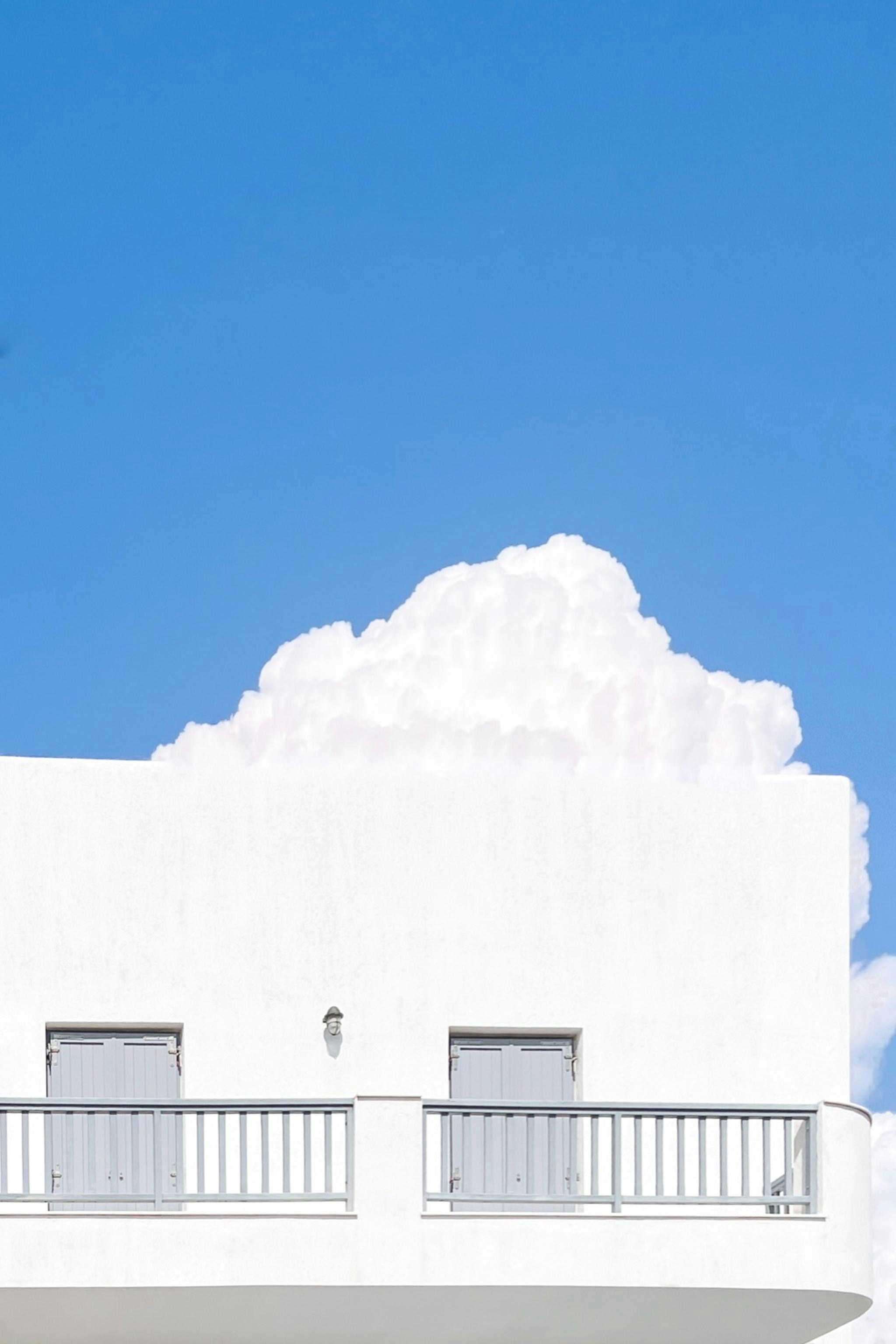 A white building with balconies and balconies on the balconies