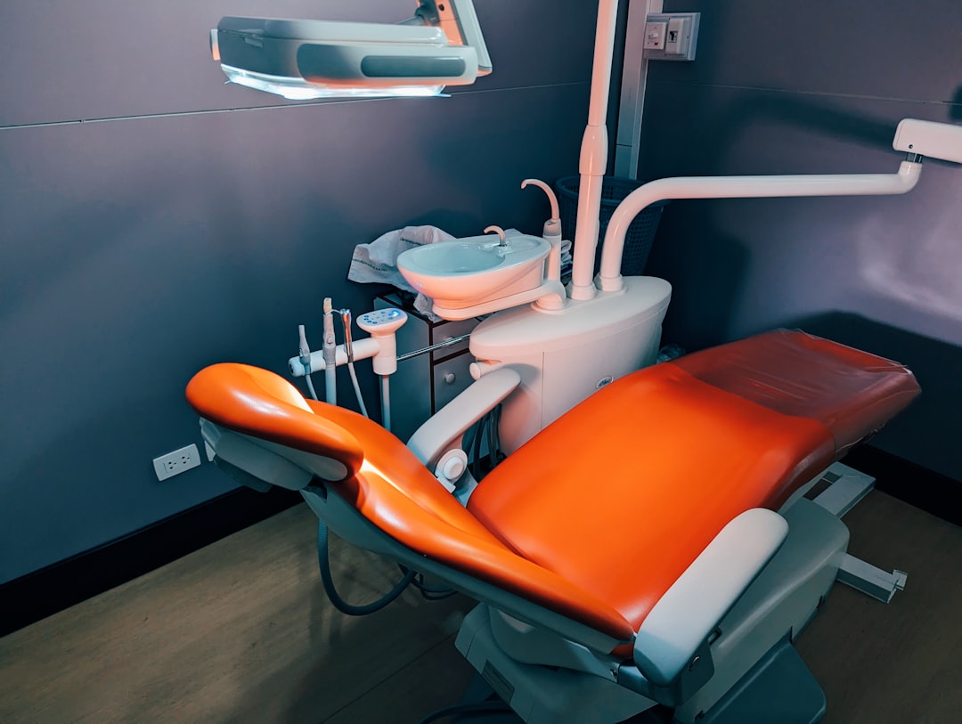 An ergonomic setup of a dental chair and operating light - Dental office lighting An ergonomic setup of a dental chair and operating light - Dental office lighting