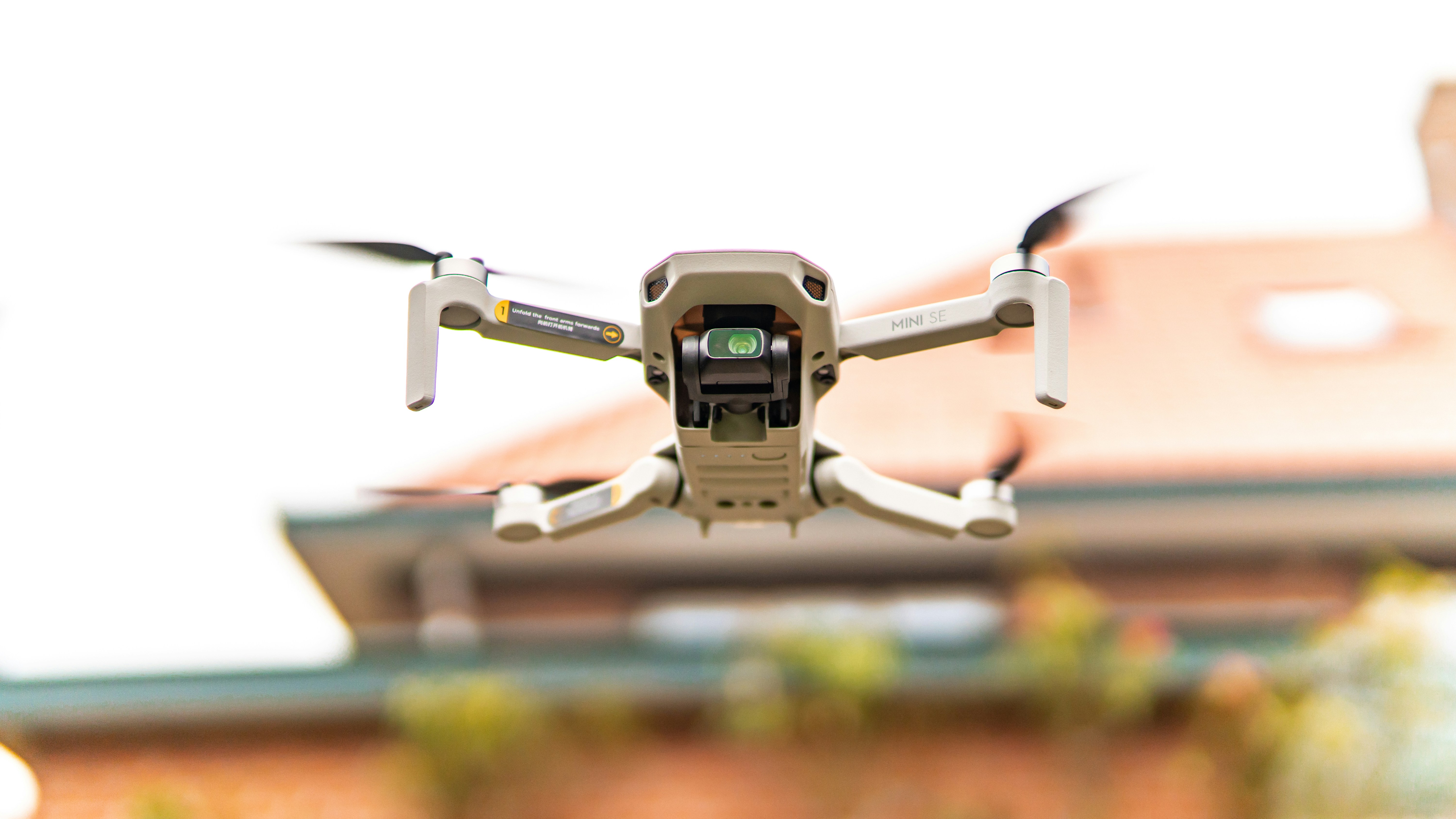 A drone flying over a residential roof, capturing high-definition images for inspection purposes - how often should you inspect your roof