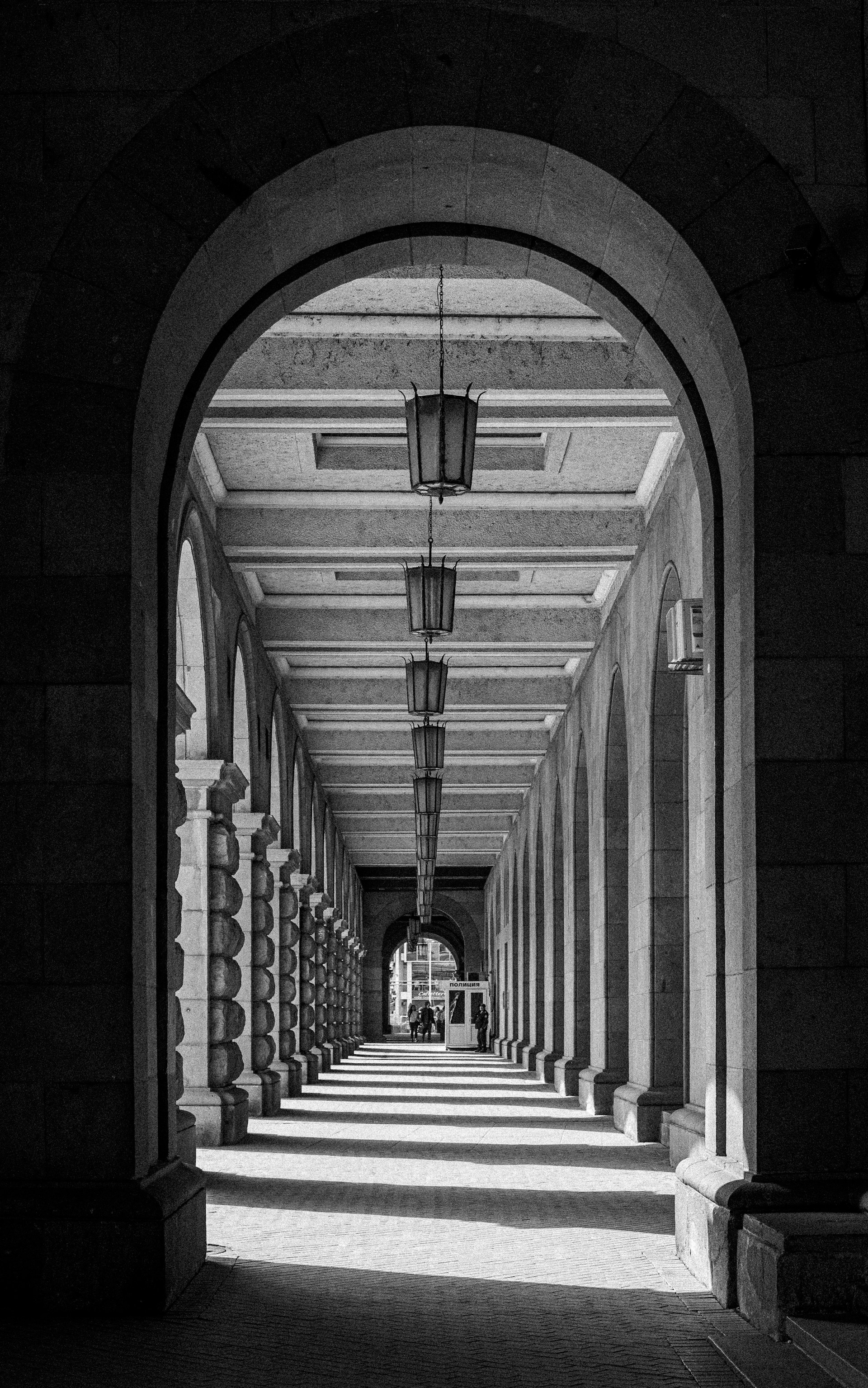 A black and white photo of a long hallway