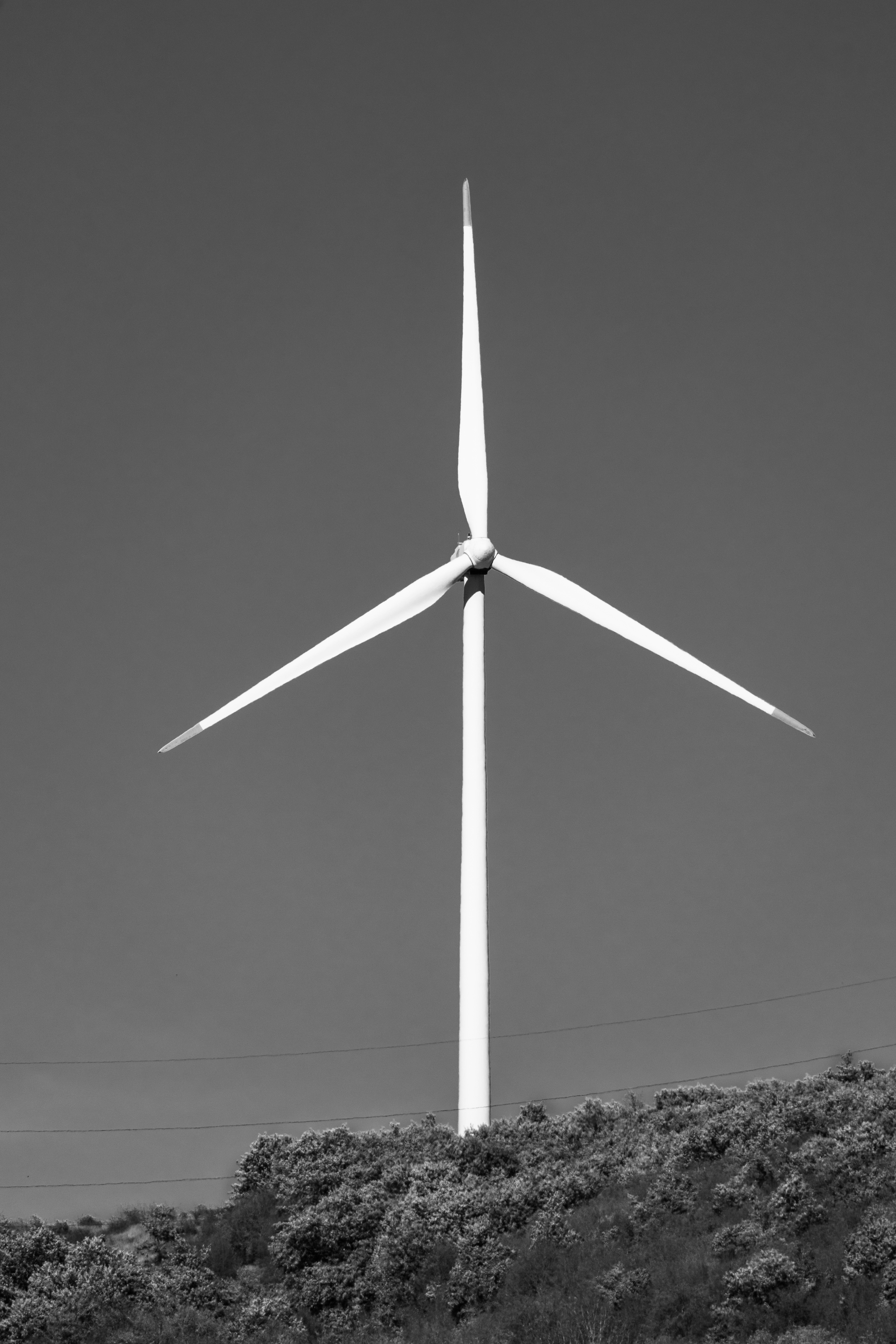 A black and white photo of a wind turbine