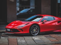 A red sports car parked in front of a building