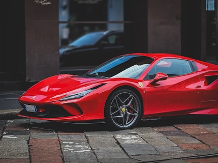 A red sports car parked in front of a building