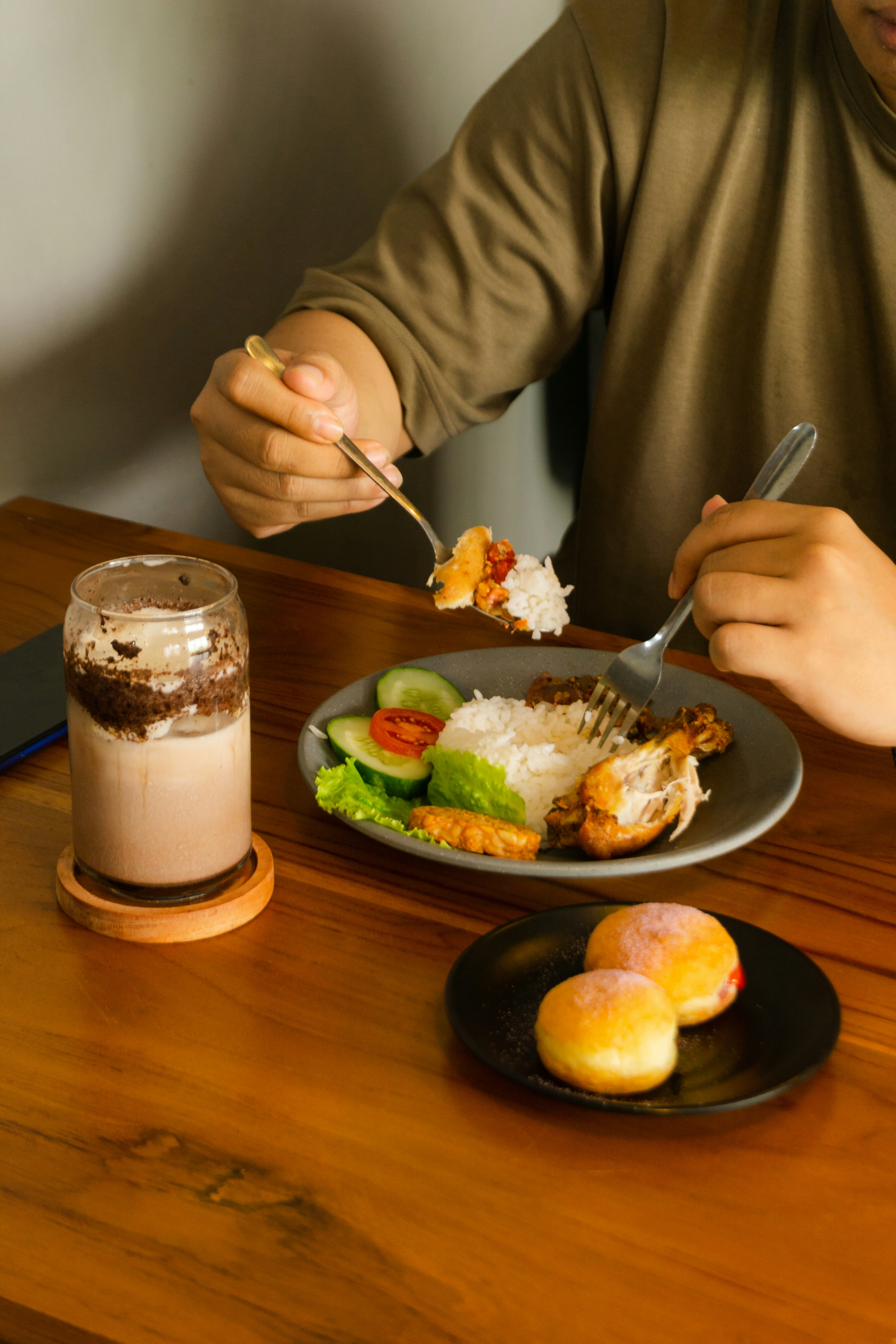 A man sitting at a table with a plate of food