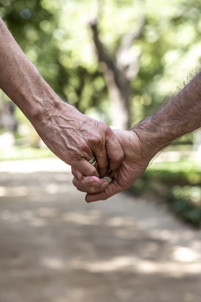 Two people holding hands, an everyday moment that begins with a first message