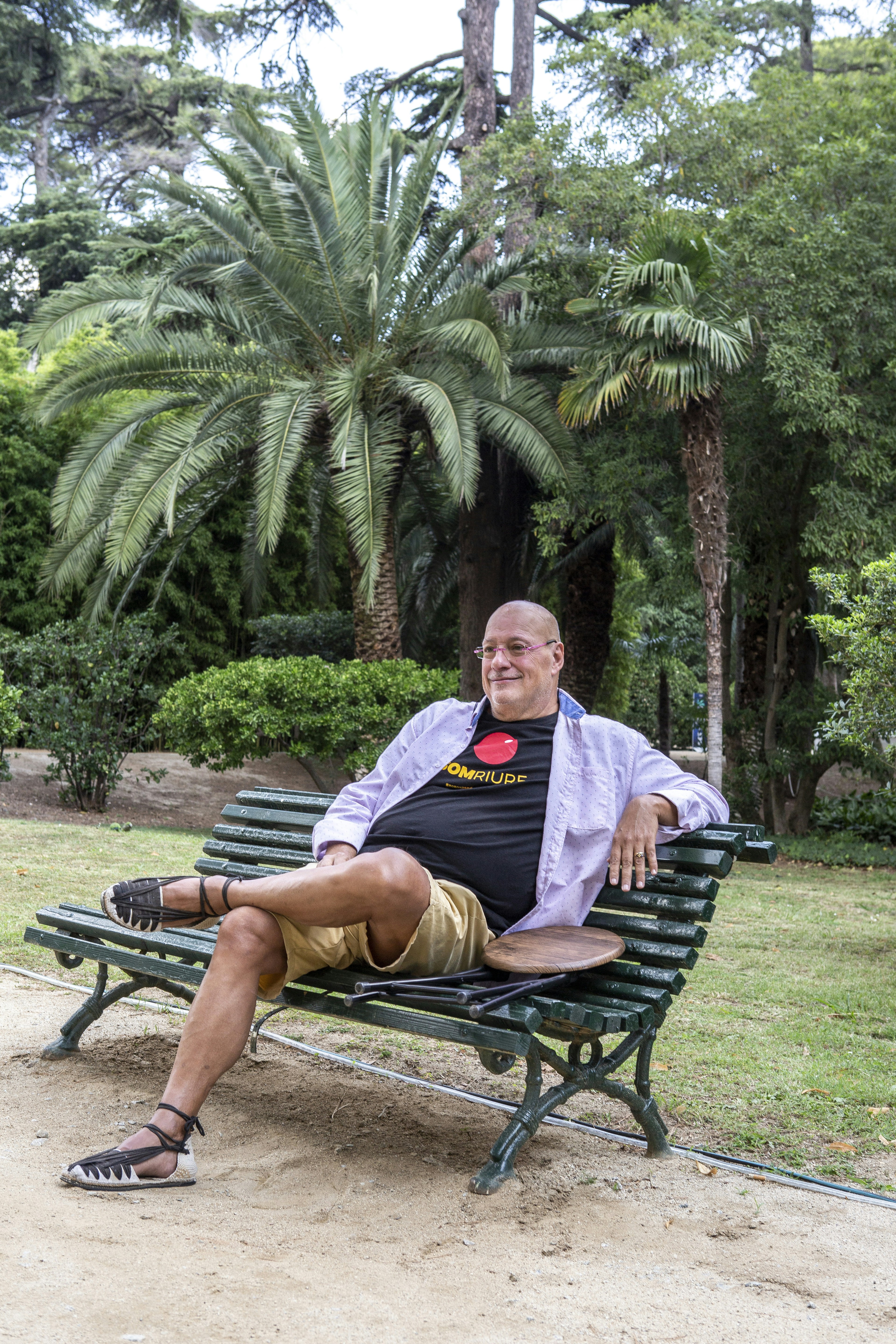 A man sitting on a bench in a park