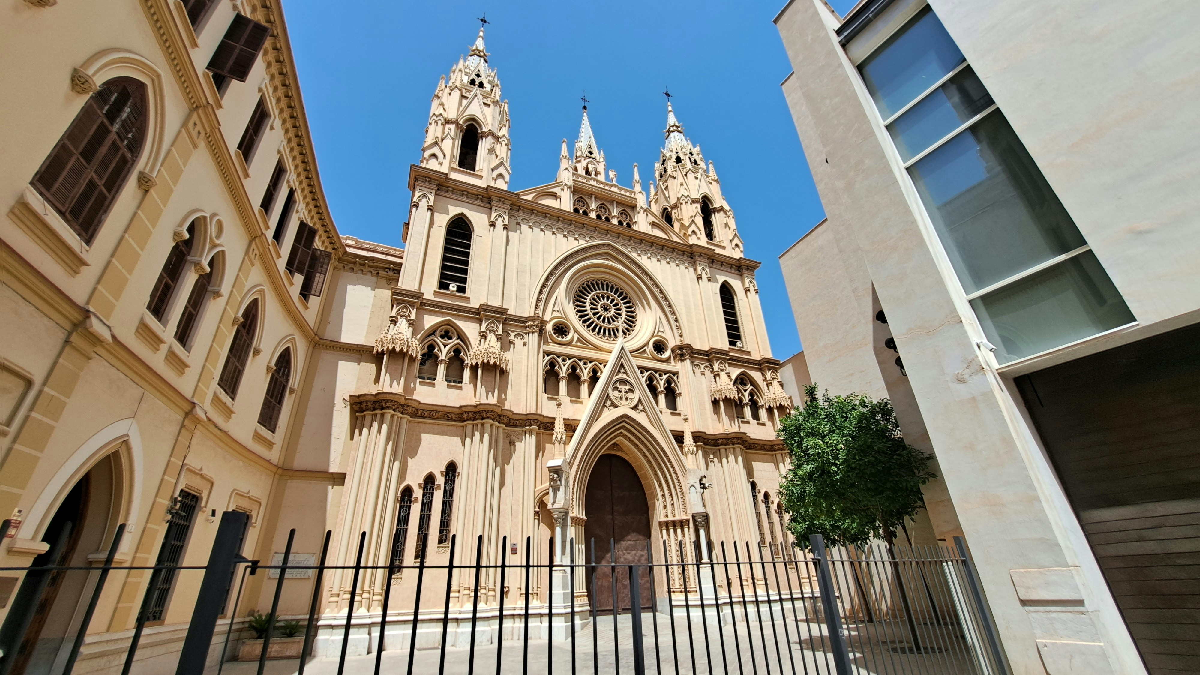 Illustrative photo: A church with a tall steeple is seen through a fence
