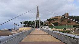 A view of a bridge with a hill in the background
