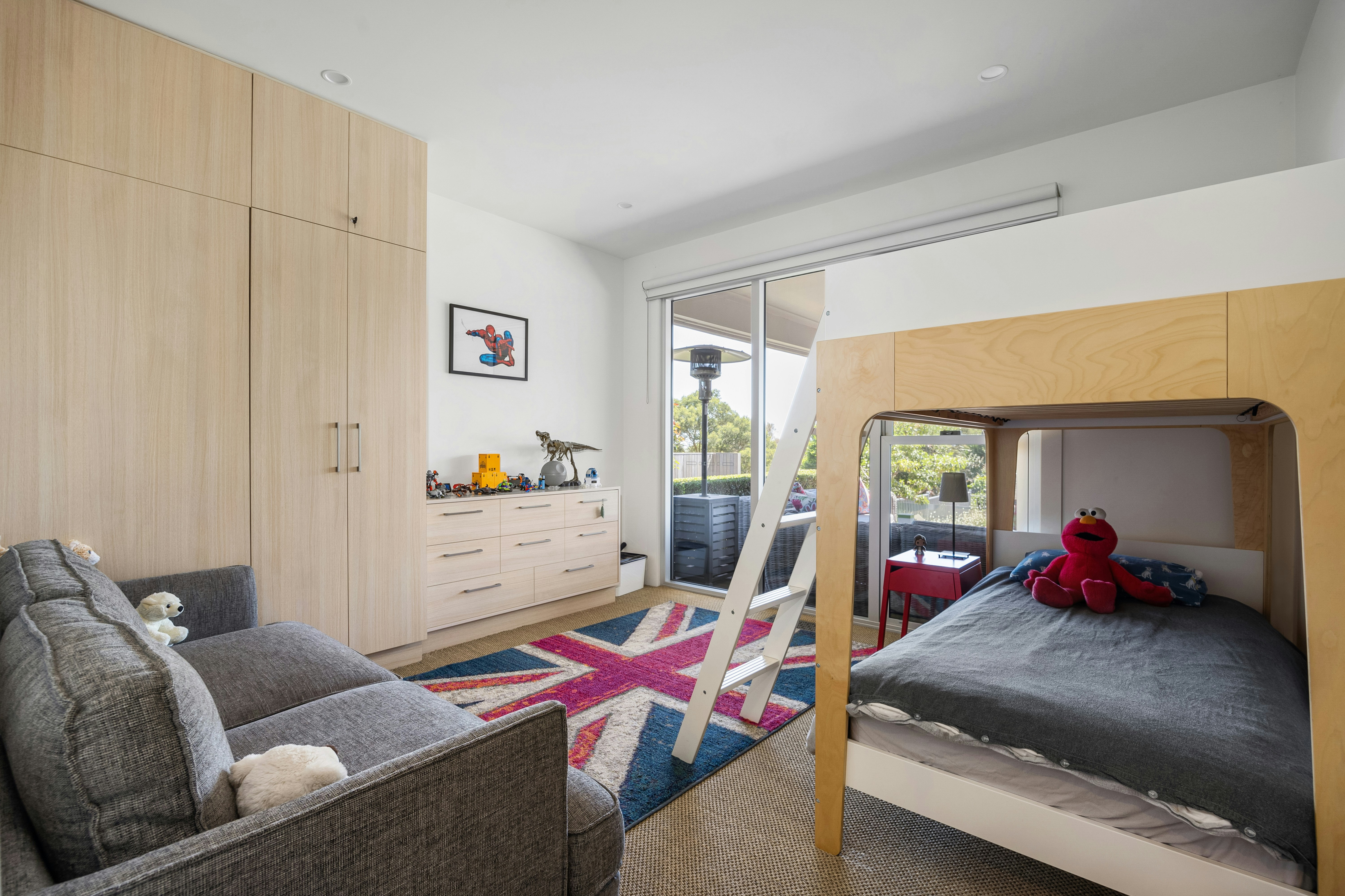 A bedroom with a bunk bed and a couch