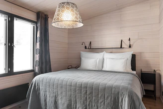 A bedroom with a bed and a window