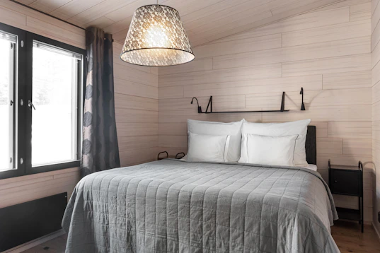 A bedroom with a bed and a window