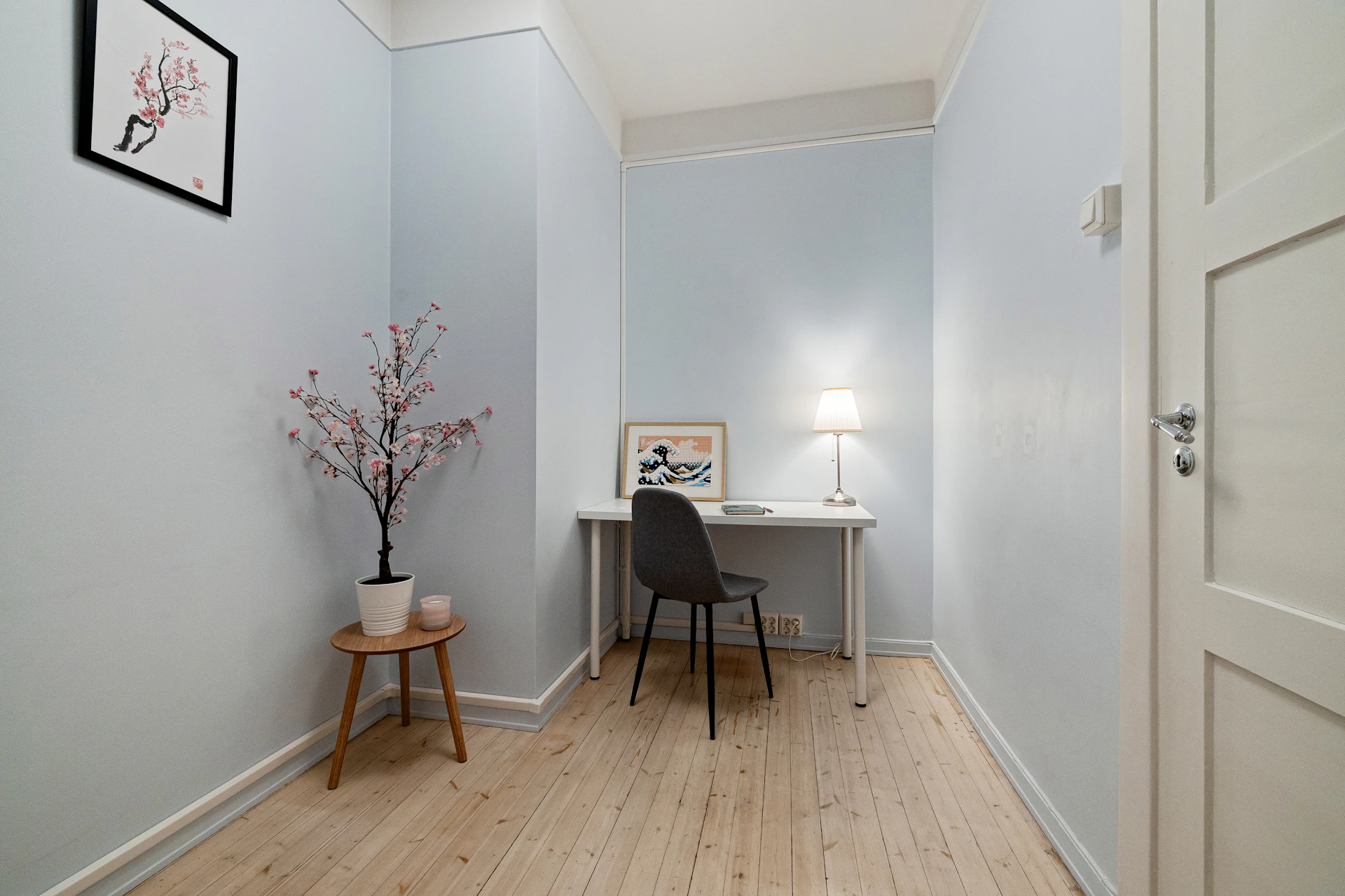 A room with a desk and a chair in it