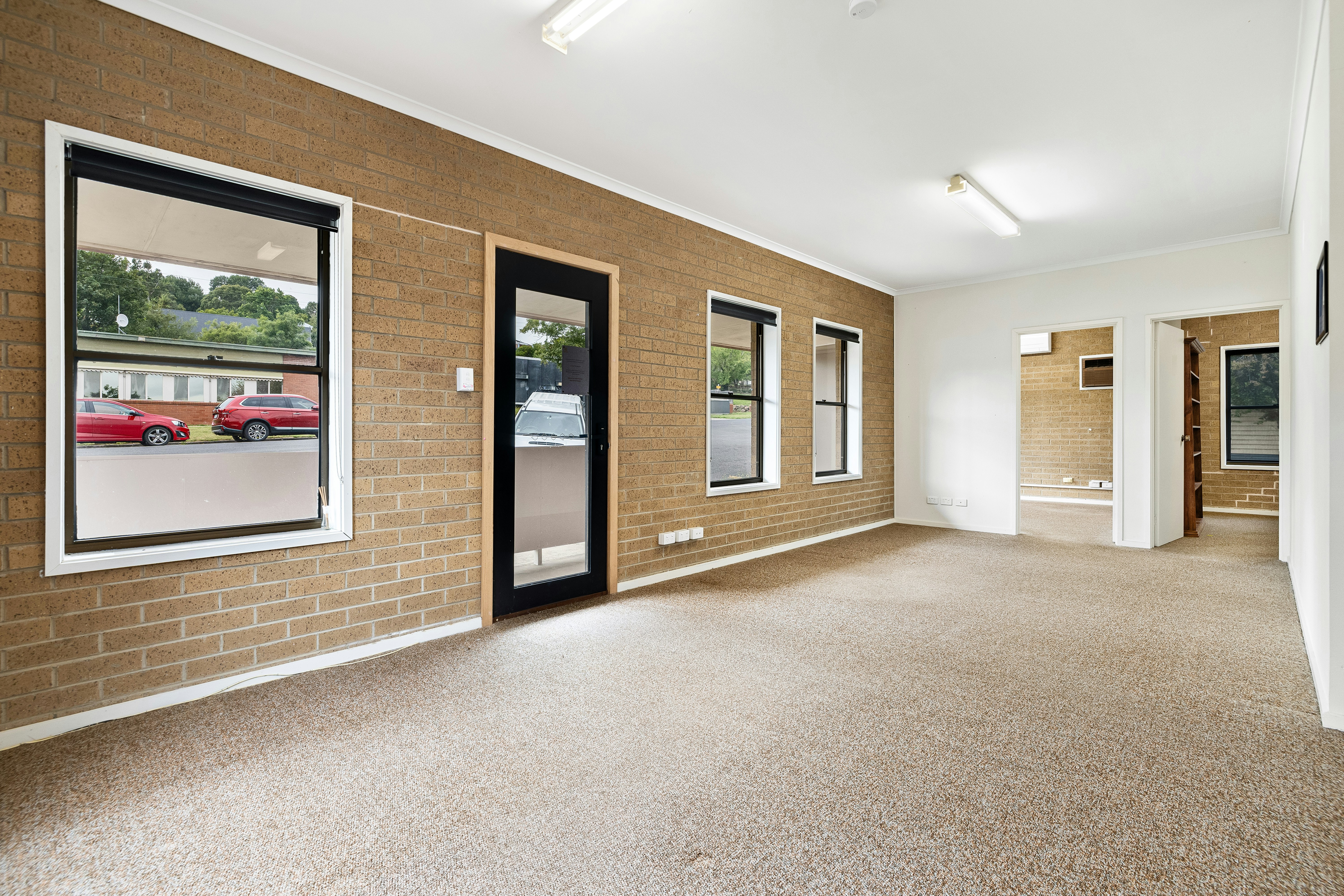 Empty room with a brick wall and carpet