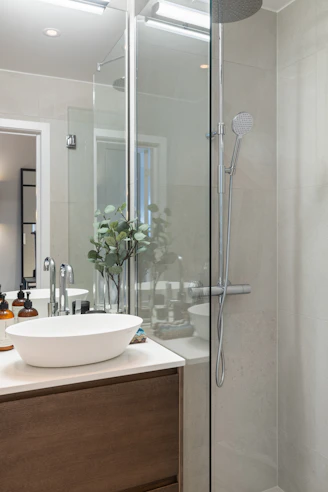 A bathroom with a sink and a shower