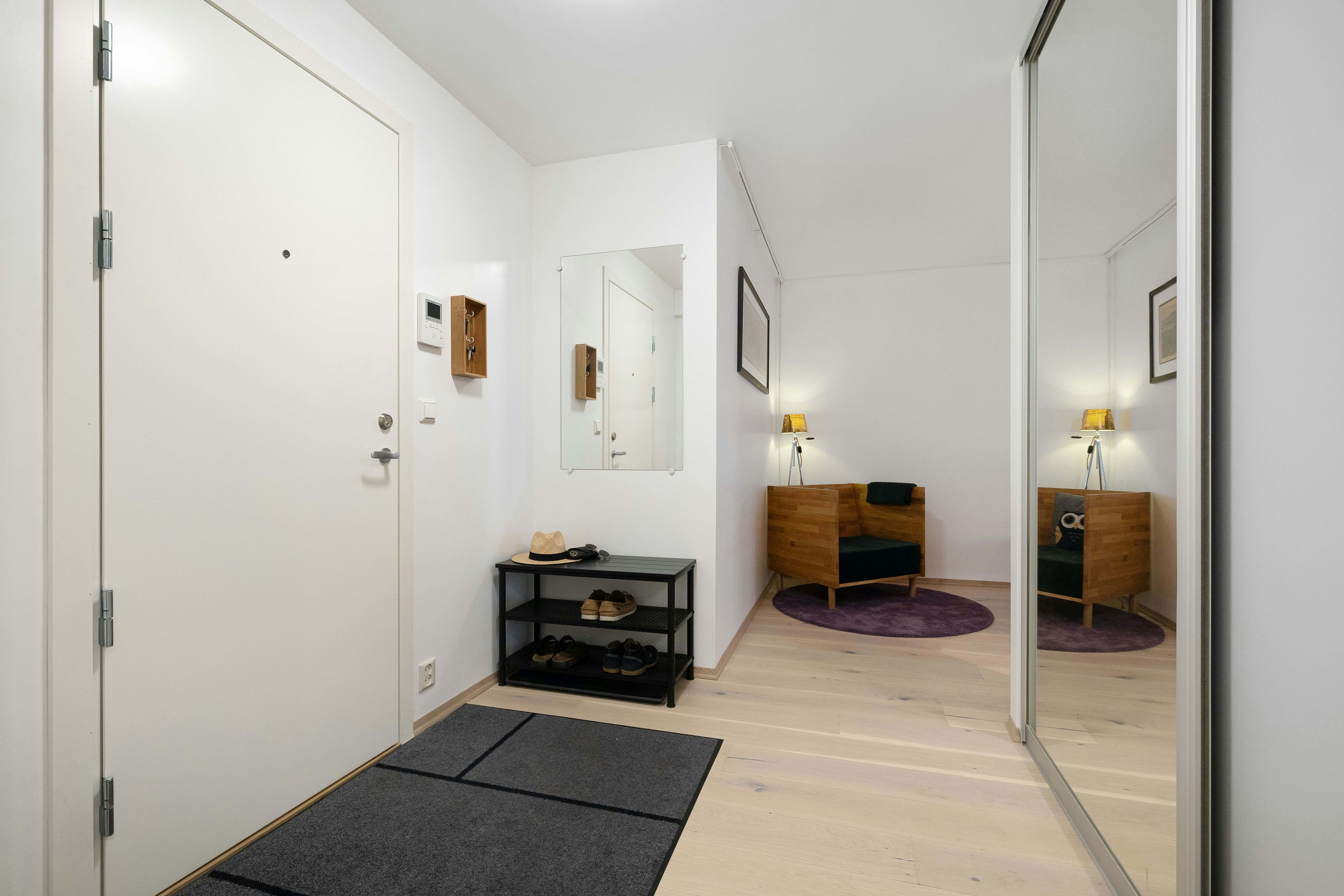 Hallway with black rug