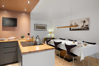 A kitchen with a table and chairs and a sink